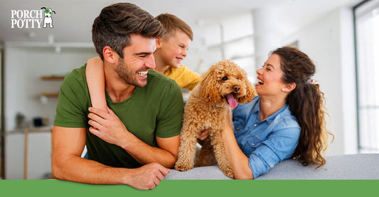 A happy family laughing and cuddling their Poodle at home, enjoying quality time together.